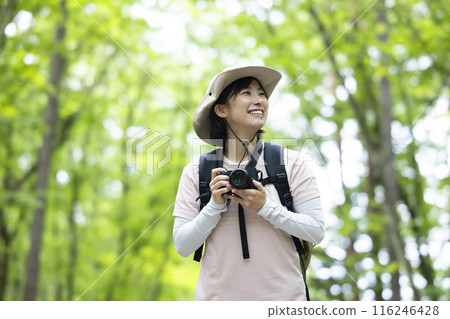 Woman taking a photo while hiking 116246428
