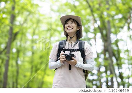 Woman taking a photo while hiking 116246429