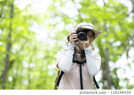 Woman taking a photo while hiking 116246430