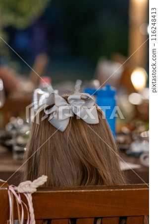 A back turned girl with beautiful ribbon hair clip . copy space  116248413
