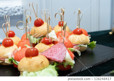 Mini Small burgers served on one plate as appetizers . Mini Small burgers served on one plate as appetizers . 116248417