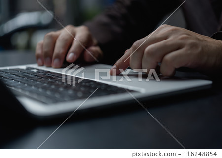 A person is typing on a laptop with a finger pointing to the screen A person is typing on a laptop with a finger pointing to the screen 116248854