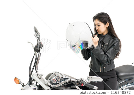 A girl riding a motorcycle and putting on a helmet for safety on her tour 116248872