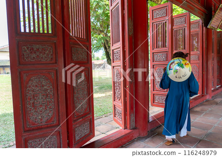 People dressed in formal attire walk along the Red Corridor of the Hue Imperial Palace, a World Heritage Site that preserves the splendor of Vietnam's last dynasty, on National Day. 116248979