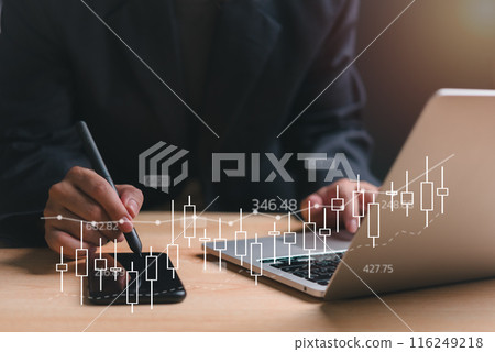 A man is using a stylus to draw on a laptop screen 116249218