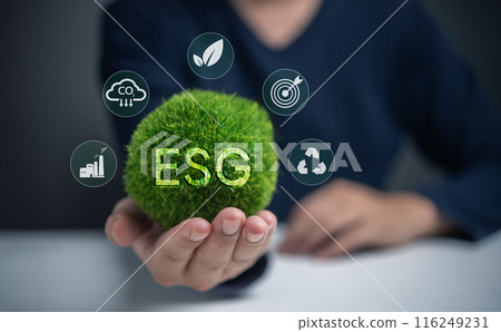 A person is holding a green ball with the letters ESG on it A person is holding a green ball with the letters ESG on it 116249231