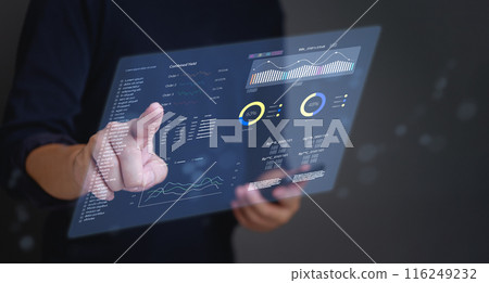 A person is using a laptop to draw graphs on a screen 116249232