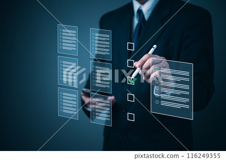 Business executive using a stylus to complete a checklist on a futuristic interface. 116249355