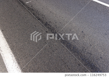 white road markings on asphalt, close up white road markings on asphalt, close up 116249753