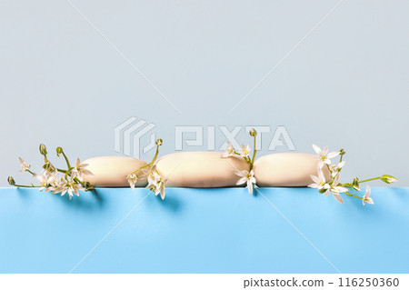 Concept scene stage showcase for new product, banner, promotion sale, cosmetic, presentation. Wood slice podium and white Ornithogalum flowers on blue background. 116250360