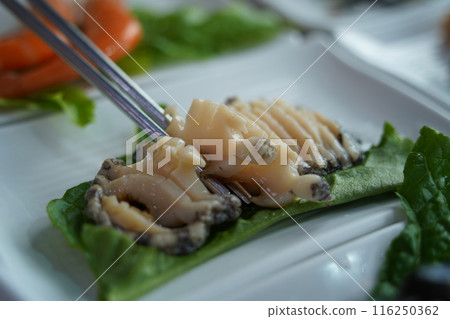 Fresh raw abalone sashimi is served Fresh raw abalone sashimi is served 116250362