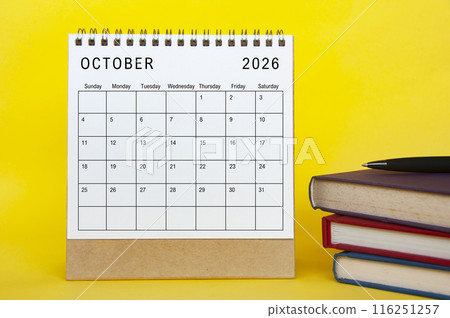 October 2026 calendar with yellow cover background and books. New month and calendar concept. 116251257