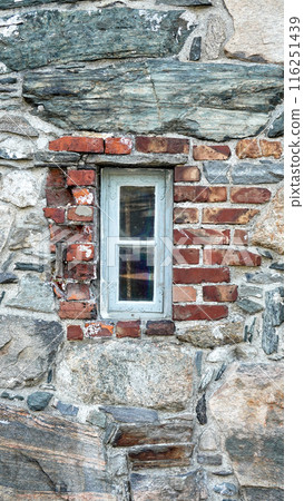 big stone wall and small window texture background Vertical big stone wall and small window texture background Vertical 116251439