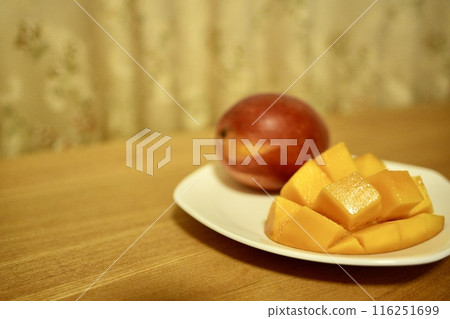 Beautiful sliced mango on a white plate 116251699