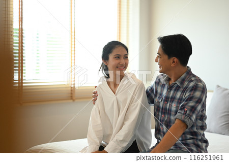 Happy young couple sitting in bedroom. New Home and relocation concept 116251961