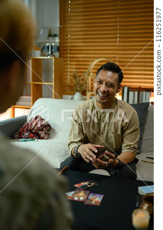 Fortune teller doing Tarot card reading and forecasting future for client in dark room Fortune teller doing Tarot card reading and forecasting future for client in dark room 116251977