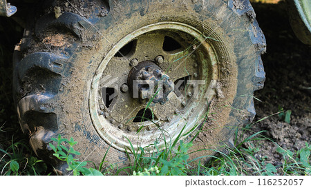 A close-up of a heavily mud-caked tire, highlighting the rugged tread pattern and the adventure of off-road driving. A close-up of a heavily mud-caked tire, highlighting the rugged tread pattern and the adventure of off-road driving. 116252057