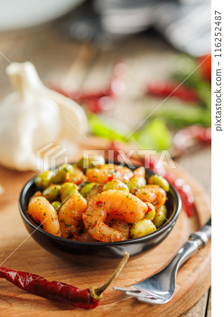 Fresh salad with shrimps and edamame soybeans in bowl on wooden table. 116252487