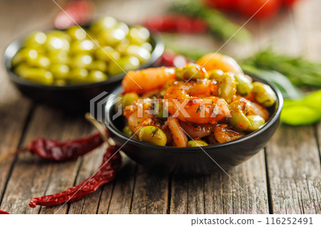 Fresh salad with shrimps and edamame soybeans in bowl on wooden table. 116252491