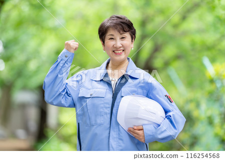 Women in work clothes, fresh green helmet Women in work clothes, fresh green helmet 116254568