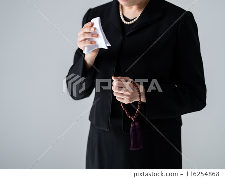 Woman in mourning clothes wiping away tears, no face Woman in mourning clothes wiping away tears, no face 116254868