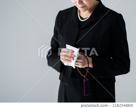 Woman in mourning clothes wiping away tears, no face Woman in mourning clothes wiping away tears, no face 116254869