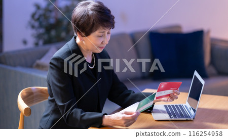 Woman in mourning clothes, bankbook, worries 116254958