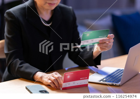 Woman in mourning clothes, bankbook in hand 116254974