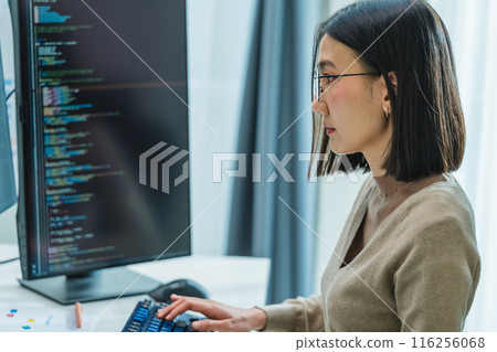 Asian prompt engineer develop coding app with software data sitting in front of computer monitor at office Asian prompt engineer develop coding app with software data sitting in front of computer monitor at office 116256068