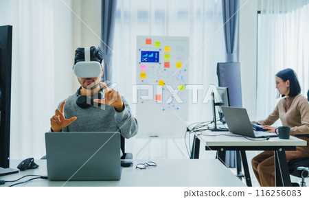 Asian and Indian developer program coding sent to virtual reality headset to implement ai project at office 116256083