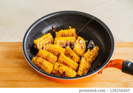 Corn baked with butter and soy sauce 116256307
