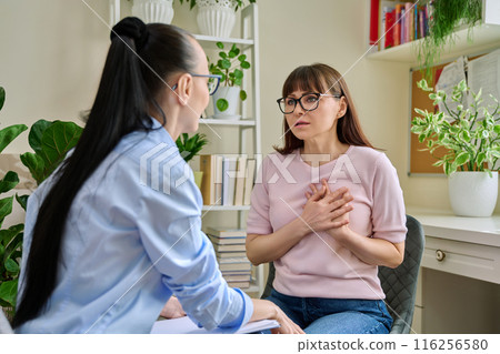 Mature sad woman in therapy session with mental professional 116256580