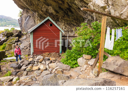 Tourist visiting Helleren houses in Jossingfjord, Norway Tourist visiting Helleren houses in Jossingfjord, Norway 116257161