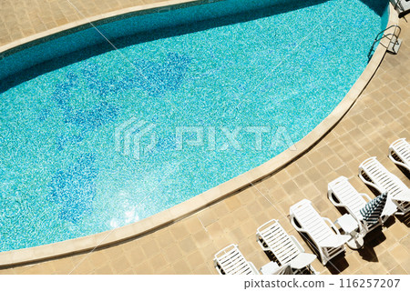 Sun-Drenched Poolside Serenity: A Tranquil Oasis for Relaxation and Recreation 116257207