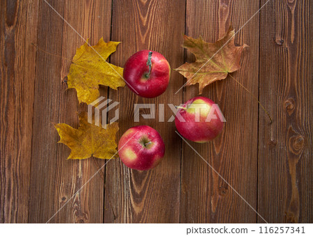 Autumn border from apples and fallen leaves Autumn border from apples and fallen leaves 116257341