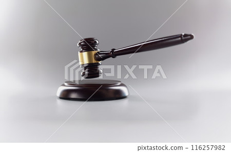 Judges wooden hammer on soundboard placed grey background Judges wooden hammer on soundboard placed grey background 116257982
