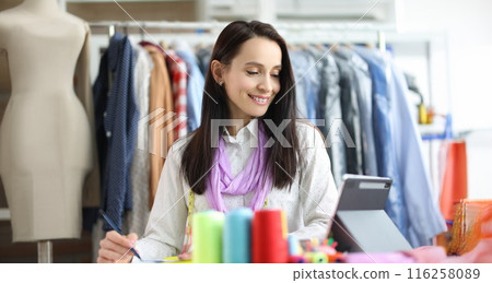 Smiling woman stylist designer at workplace in atelier 116258089