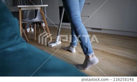 Female wiping wooden laminate with mop, domestic work, housewife cleaning at home Female wiping wooden laminate with mop, domestic work, housewife cleaning at home 116258148