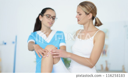 Physiotherapist give advice to female patient, rehabilitation after injury or accident 116258183