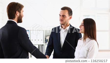 Couple shaking hands with realtor or lawyer, greet specialist in office Couple shaking hands with realtor or lawyer, greet specialist in office 116258217