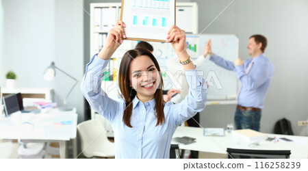 Woman lift document over head, celebrate good deal, beneficial agreement 116258239