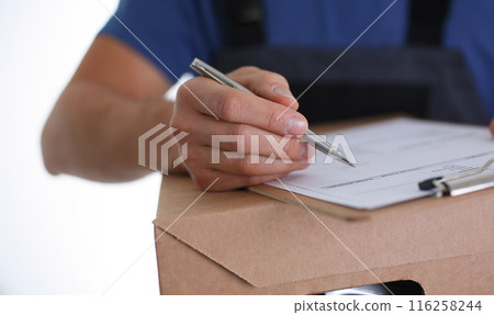 Man put signature on delivery receipt paper, got package from delivery service company Man put signature on delivery receipt paper, got package from delivery service company 116258244