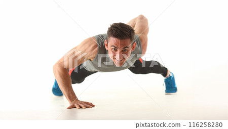 Strong man perform biceps and triceps workout at home without equipment 116258280