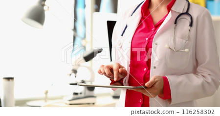 Doctor open patient medical history on tablet device, modern technologies in clinic Doctor open patient medical history on tablet device, modern technologies in clinic 116258302