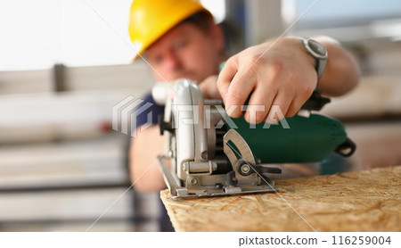 Male worker using electric saw tool, improvement on construction site, diy inspiration Male worker using electric saw tool, improvement on construction site, diy inspiration 116259004