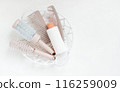 Different hair combs and plastic bottle on white background. The concept of hair care. Template for cosmetics products. 116259009