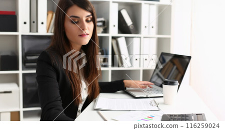 Woman secretary on workplace, busy with planning, laptop device on desk 116259024