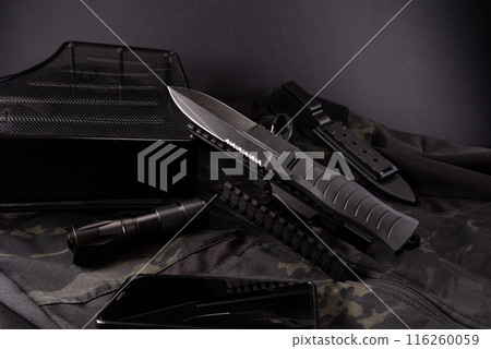 Large military knife. Military accessories and knife. Military composition on a black background. Large military knife. Military accessories and knife. Military composition on a black background. 116260059