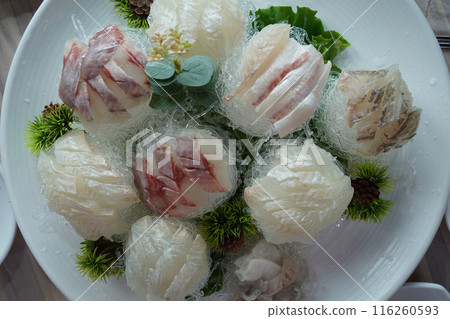 A table of fresh raw fish is served 116260593
