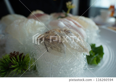 A table of fresh raw fish is served 116260594